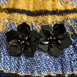 Black flower earrings.
